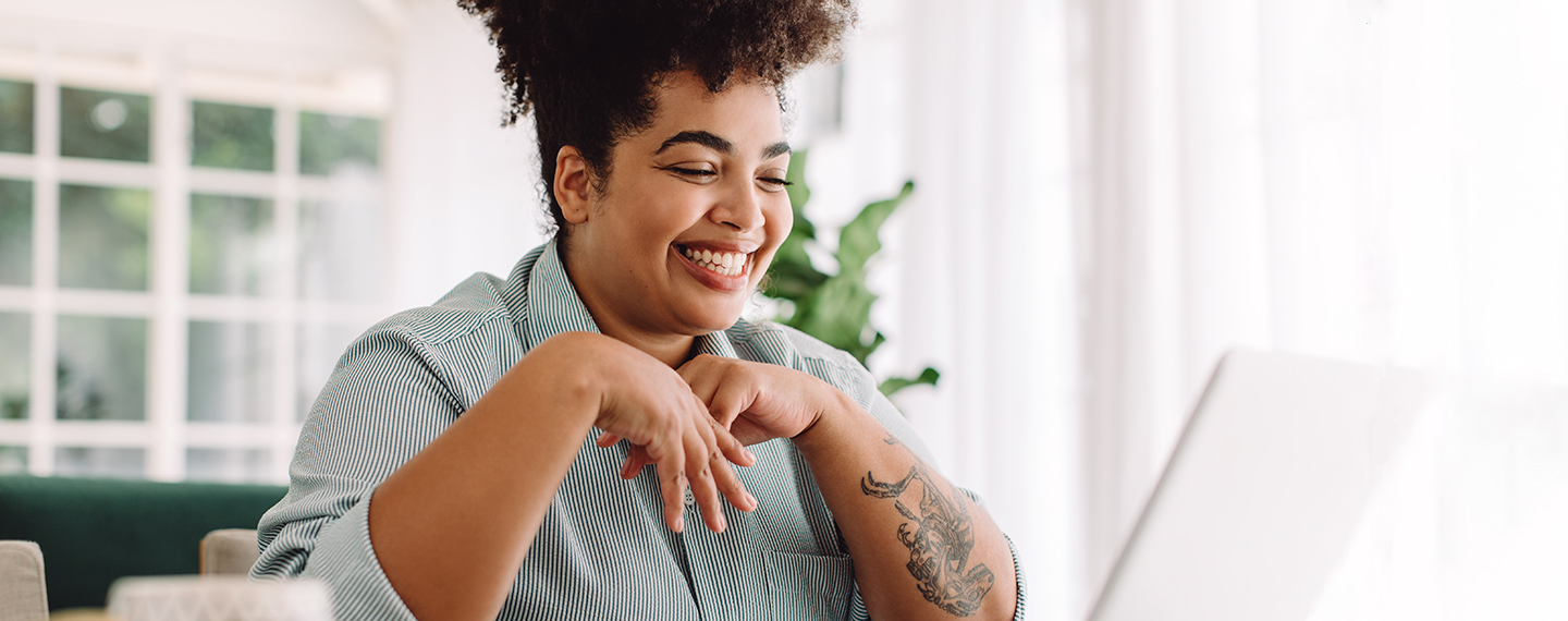 Smiling woman working on her computer at home